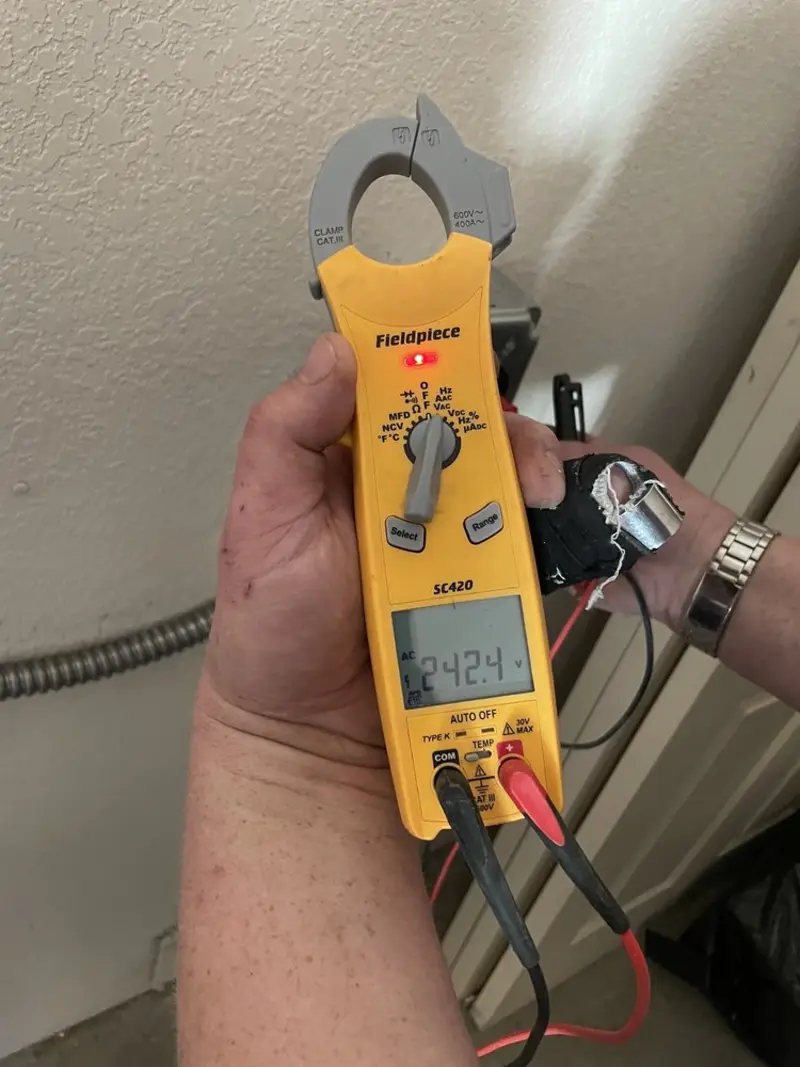 Voltage testing with clamp meter during Outlet Installation in Rio Rancho